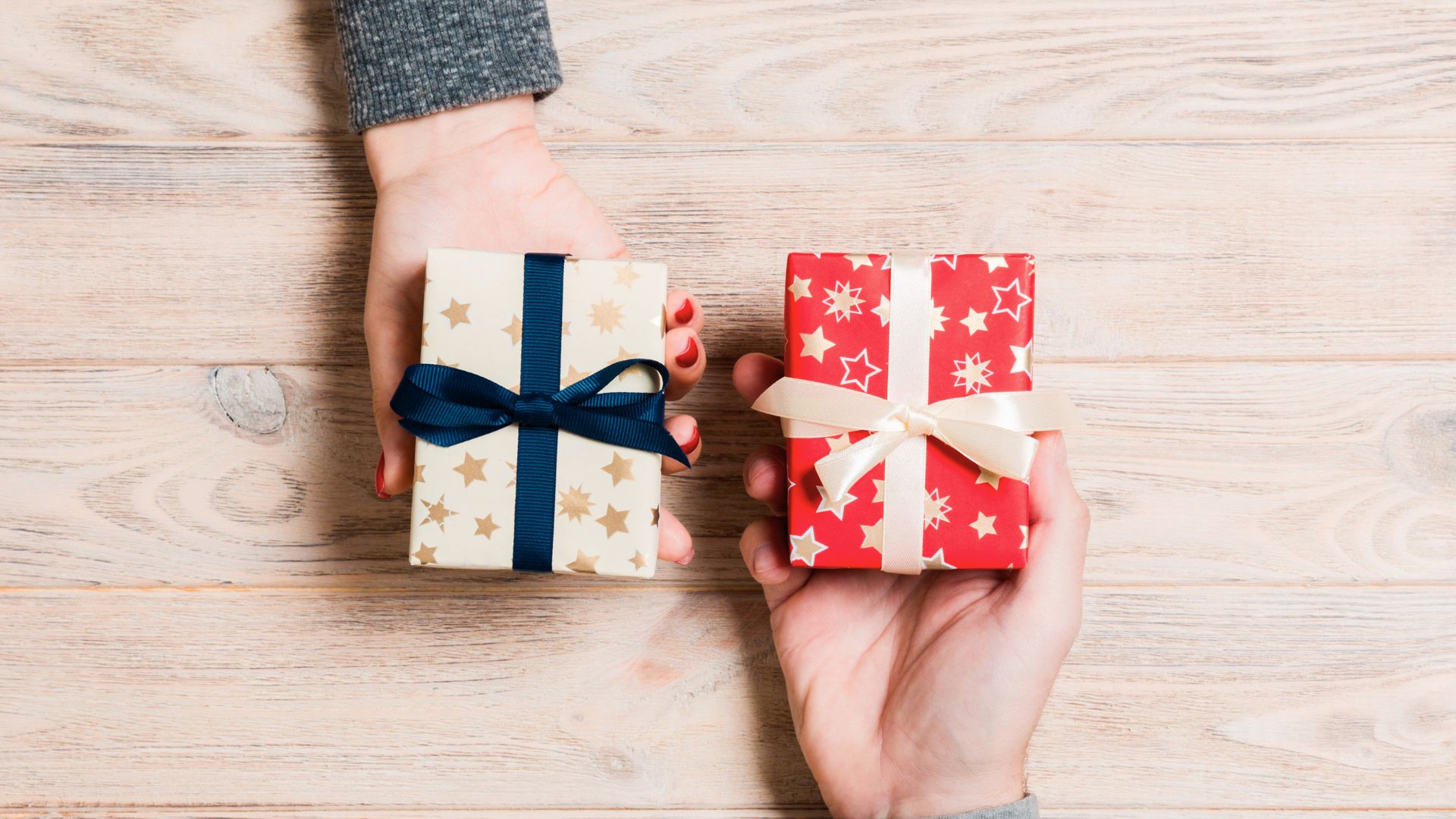 Elegant gift boxes with satin ribbons on a wooden table, showcasing luxurious packaging options for skincare, supplements, or health products by Structure Formulations.